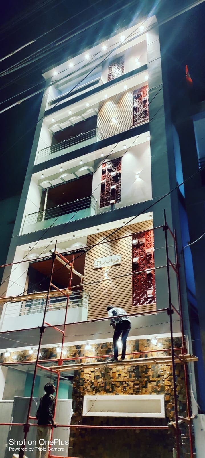 Stone-Clad Elevation, Night Reveal, a residential project (G+3) by ASRG Construction in Kurnool